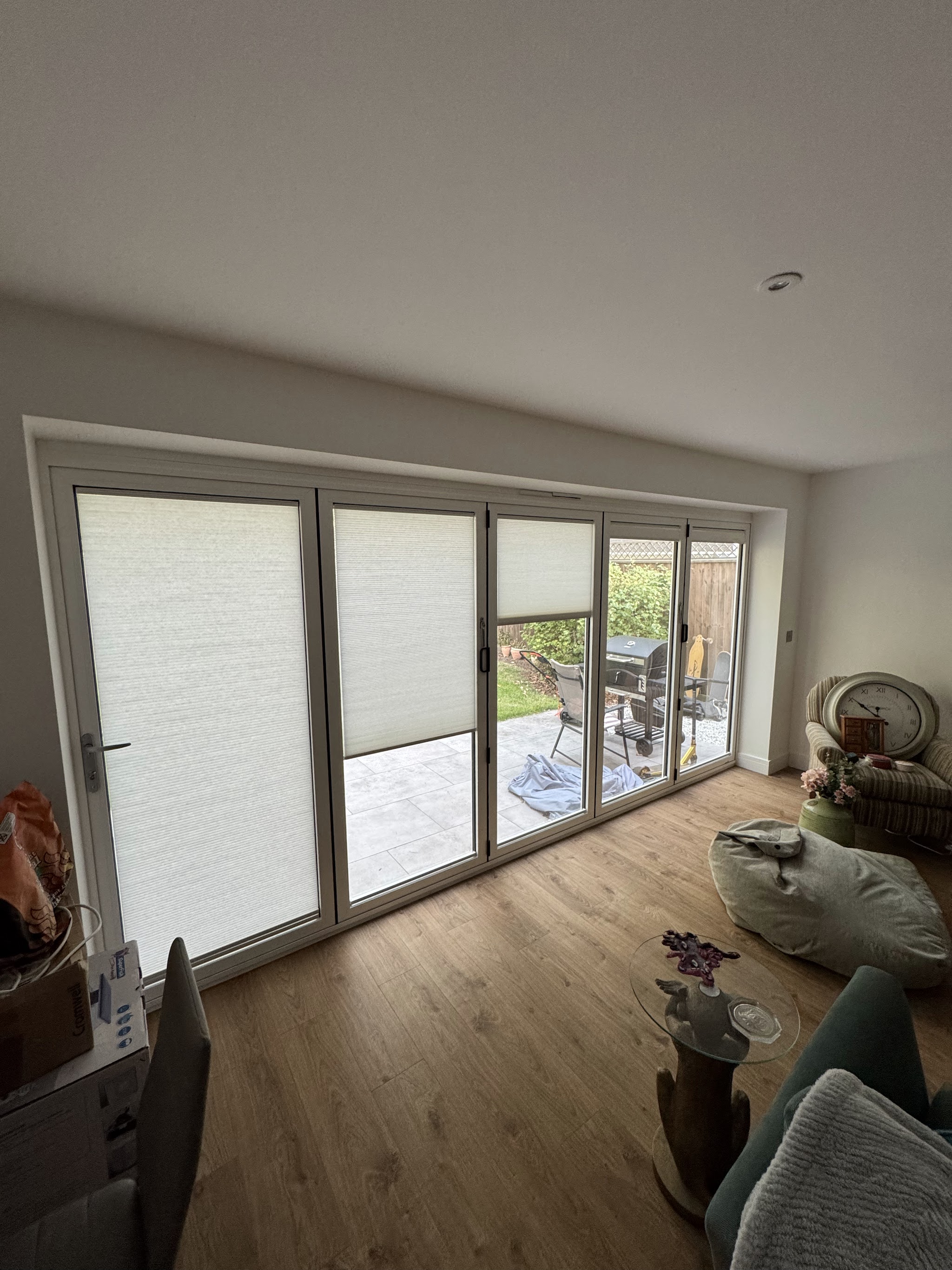Bright living room with bifold doors and fitted blinds
