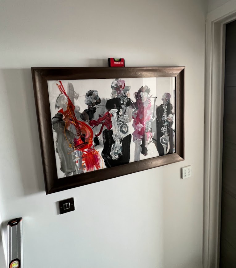 Framed artwork hung level on a hallway wall
