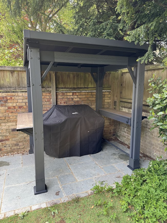 Grey barbecue gazebo built on a patio