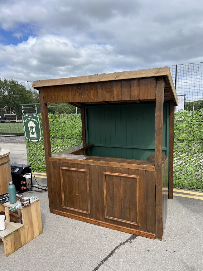 Timber bar unit with a green interior, built outdoors